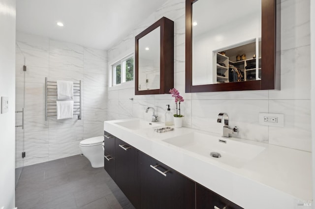 35 Bernard St, Mill Valley, CA 94941 - full bathroom with tile walls, radiator heating unit, double vanity, toilet, and a walk in closet