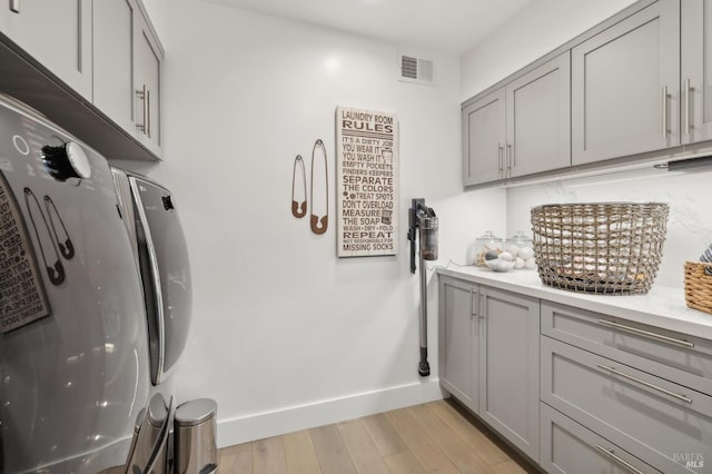 35 Bernard St, Mill Valley, CA 94941 - washroom featuring cabinet space, baseboards, light wood finished floors, and separate washer and dryer