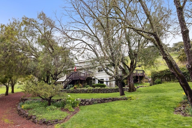 view of yard featuring stairway and a deck