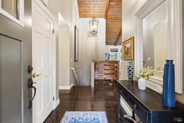 foyer with baseboards, dark wood-style flooring, lofted ceiling, and wood ceiling