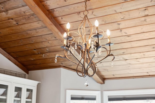 interior details featuring an inviting chandelier, wooden ceiling, and beamed ceiling