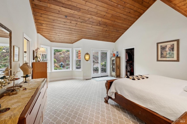 bedroom featuring high vaulted ceiling, wood ceiling, light carpet, a walk in closet, and baseboards