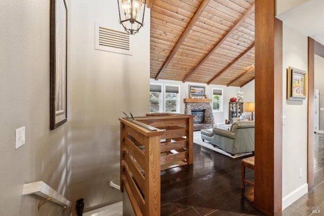 hall featuring a notable chandelier, wood ceiling, vaulted ceiling with beams, dark wood-style floors, and baseboards