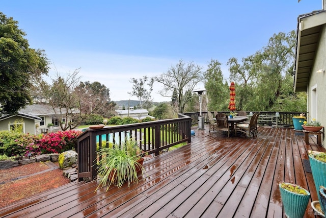 wooden deck featuring outdoor dining area