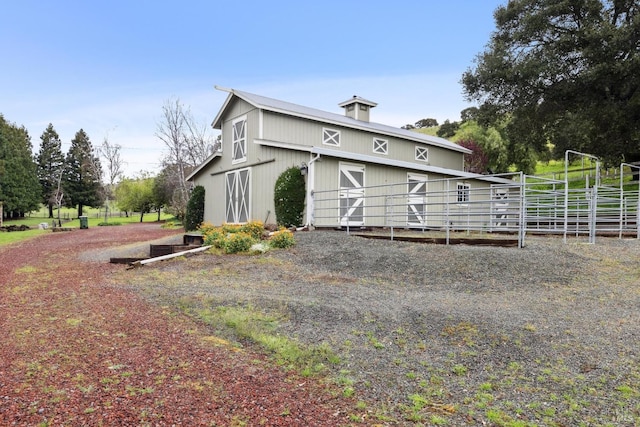 view of home's exterior featuring an outdoor structure and fence