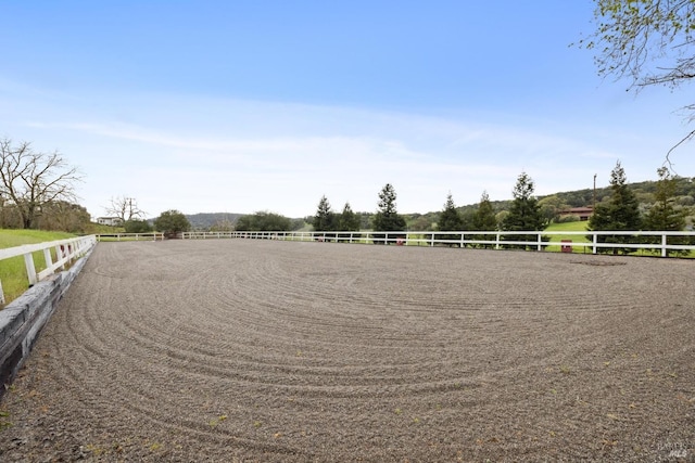 surrounding community with a rural view and an enclosed area