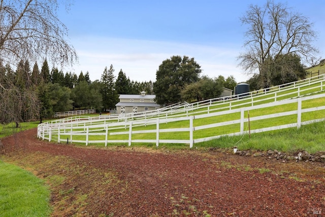 view of yard featuring fence and a rural view