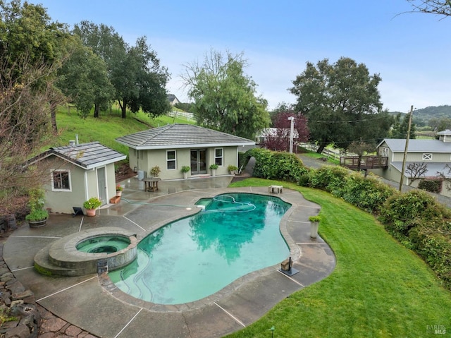 view of pool with a patio area, an outdoor structure, an exterior structure, and a yard