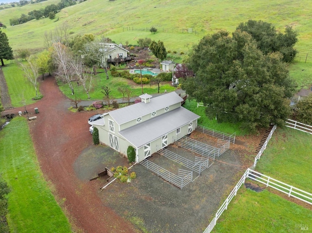birds eye view of property with a rural view