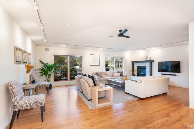 1777 Adams St, Saint Helena, CA 94574 - living room with rail lighting, a fireplace, light wood-style floors, and a ceiling fan