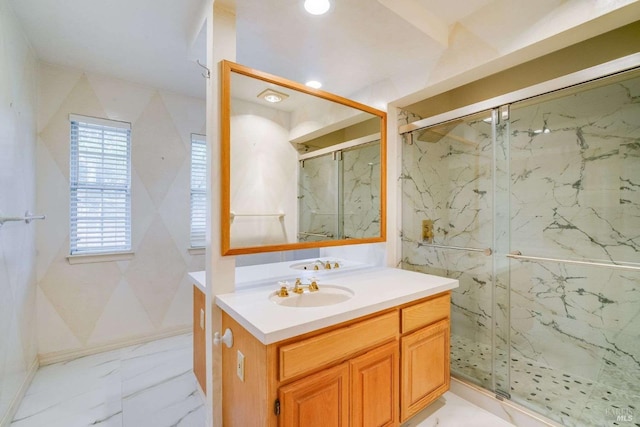 bathroom with marble finish floor, vanity, and a marble finish shower