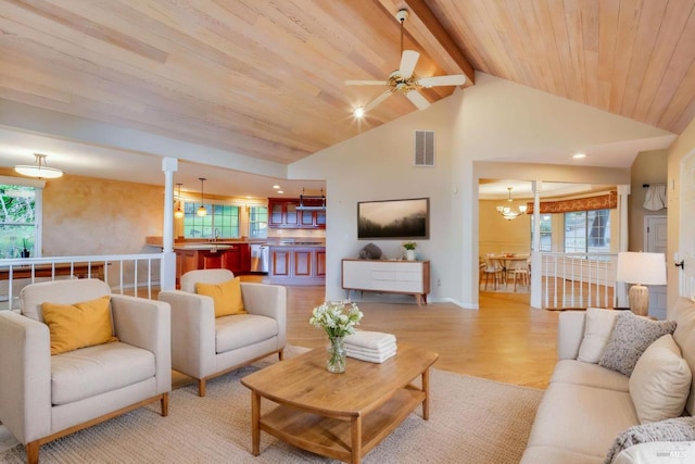 living area with wooden ceiling, ceiling fan with notable chandelier, beam ceiling, light wood finished floors, and visible vents