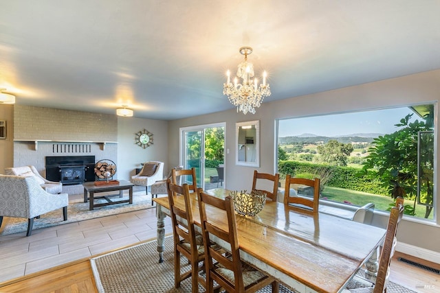 dining space with visible vents, a chandelier, and light wood finished floors