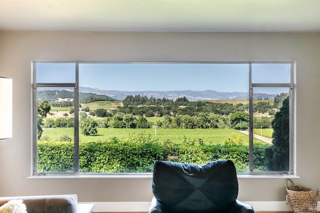 interior space with baseboards, a mountain view, and a wealth of natural light