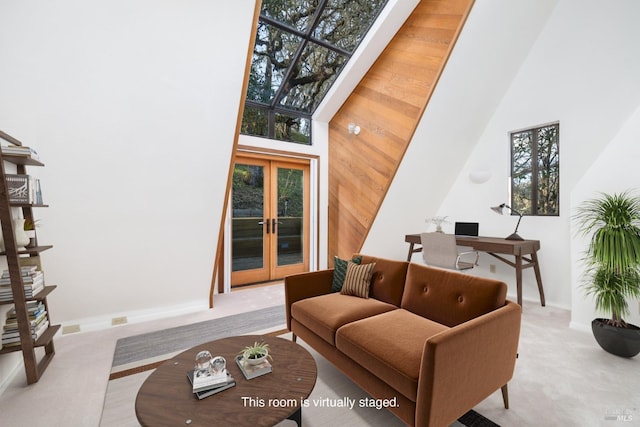 living area featuring carpet flooring, a high ceiling, french doors, and baseboards