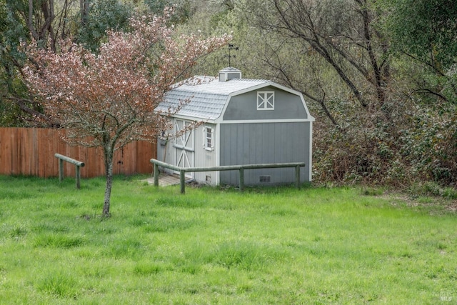 view of shed featuring fence