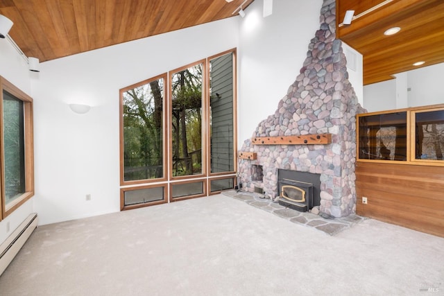 unfurnished living room featuring recessed lighting, a wood stove, wooden ceiling, a baseboard heating unit, and carpet flooring