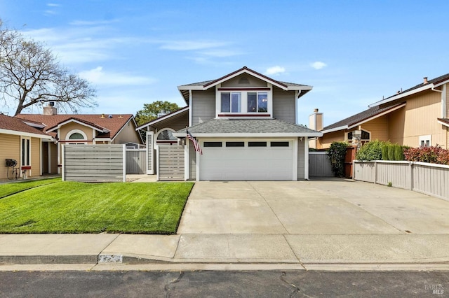 traditional-style house featuring an attached garage, a gate, fence, a front lawn, and driveway