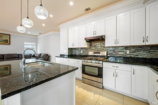 kitchen featuring decorative backsplash, a sink, stainless steel range with gas cooktop, open floor plan, and under cabinet range hood