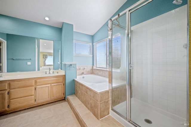 full bathroom with double vanity, a bath, a shower stall, a sink, and tile patterned floors
