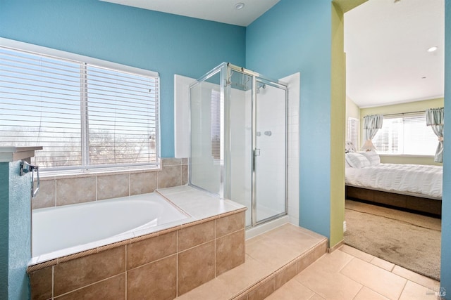 ensuite bathroom featuring tile patterned floors, a shower stall, a bath, and connected bathroom