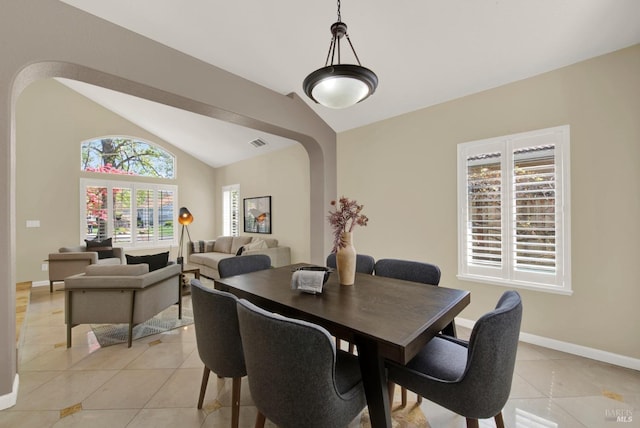 dining room featuring lofted ceiling, visible vents, and light tile patterned floors
