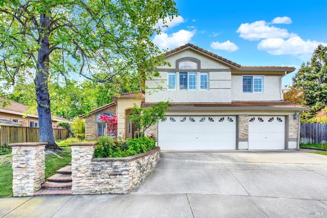 view of front of home featuring a tile roof, stone siding, a garage, and concrete driveway