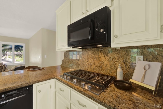 kitchen with white cabinetry, dark stone counters, black appliances, and decorative backsplash