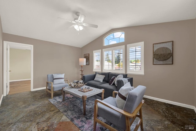 living room featuring baseboards, lofted ceiling, stone finish flooring, and a ceiling fan