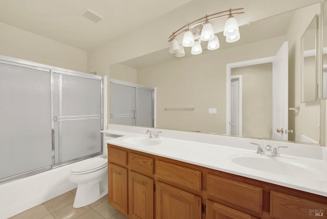 full bathroom with a sink, visible vents, tile patterned floors, and bath / shower combo with glass door