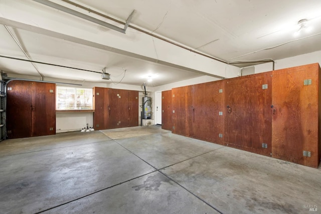 garage featuring water heater and a garage door opener