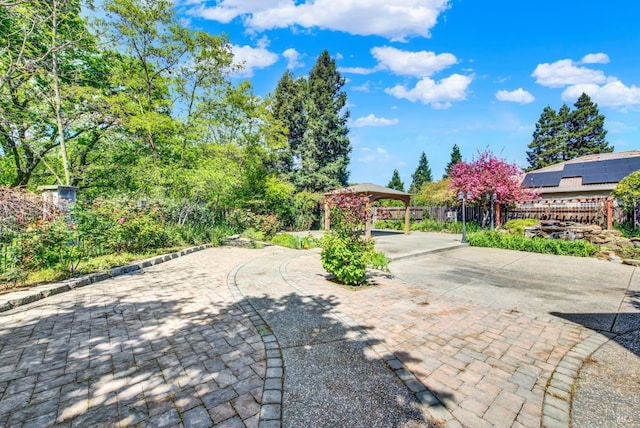 exterior space with fence and curved driveway