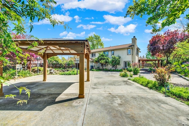 exterior space featuring fence, a gazebo, and a patio area