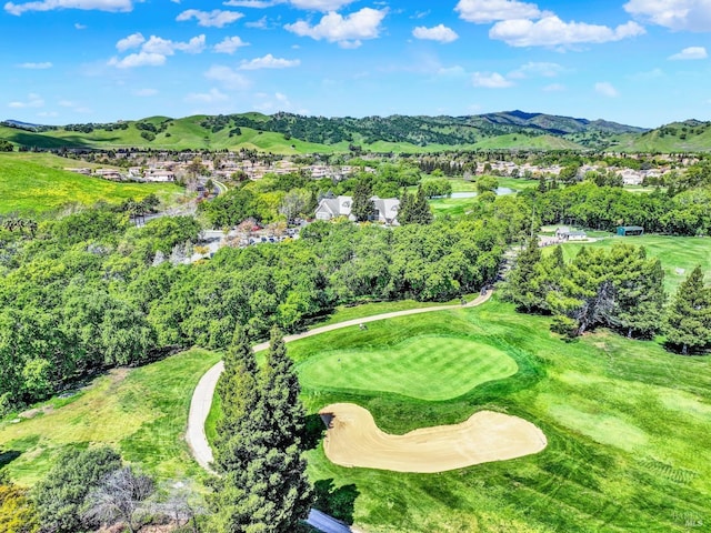 bird's eye view featuring golf course view and a mountain view