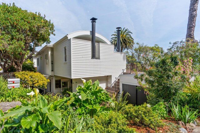 view of side of property with stairs