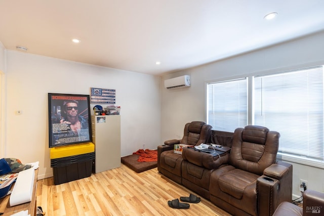 living area with light wood-style flooring, a wall unit AC, and recessed lighting
