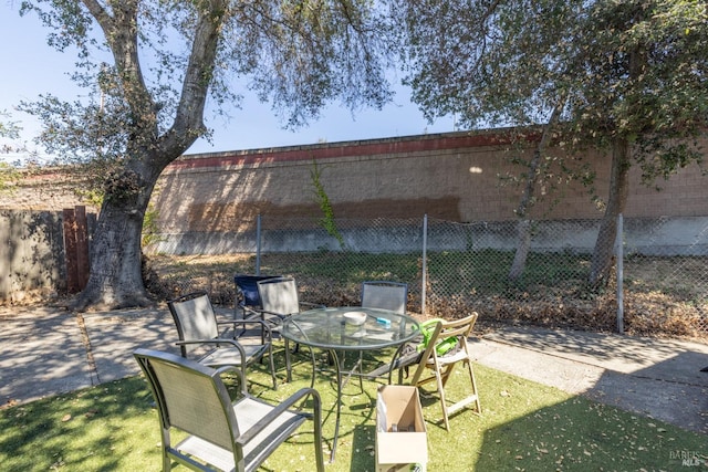 view of patio / terrace featuring outdoor dining area and fence