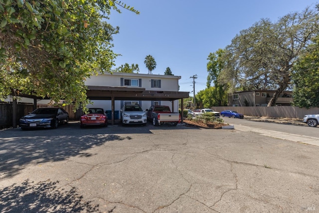 view of front of property with covered parking and fence