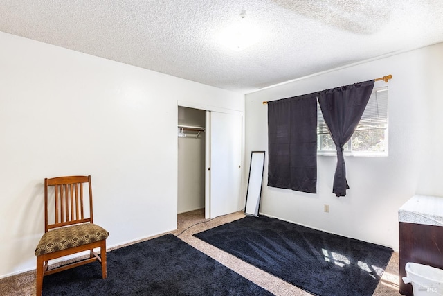 unfurnished bedroom featuring carpet flooring, a closet, and a textured ceiling