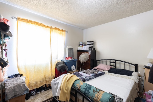 bedroom featuring carpet floors and a textured ceiling