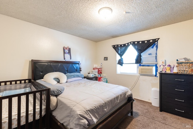 carpeted bedroom featuring a textured ceiling and cooling unit