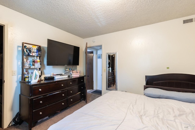 bedroom with carpet, a textured ceiling, and visible vents