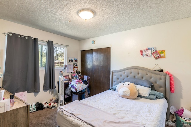 carpeted bedroom with a closet and a textured ceiling