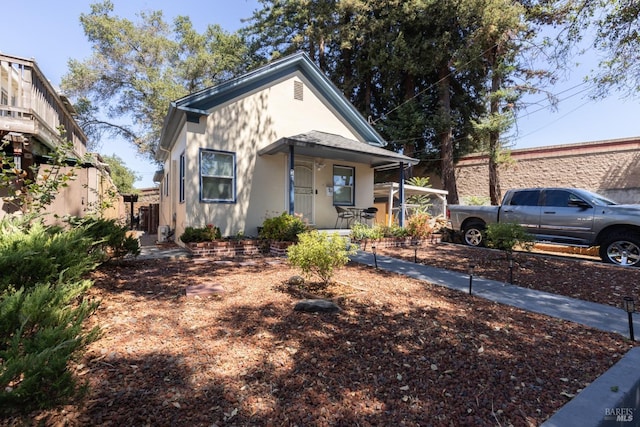 view of front of home featuring stucco siding and a porch