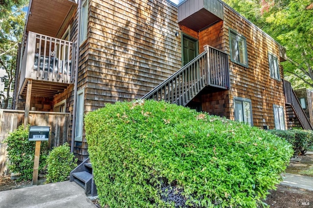view of side of property featuring stairs