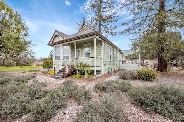 view of front of house with covered porch and a shingled roof