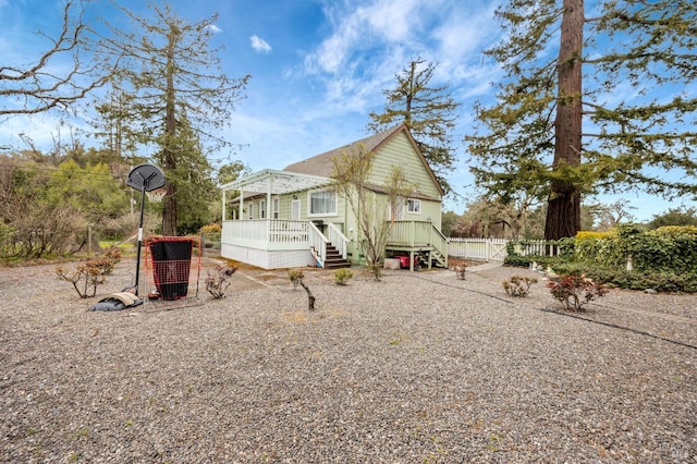 back of house with fence, stairway, and a deck