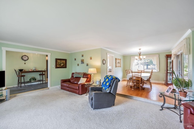 living area featuring a notable chandelier, crown molding, carpet floors, wood finished floors, and baseboards