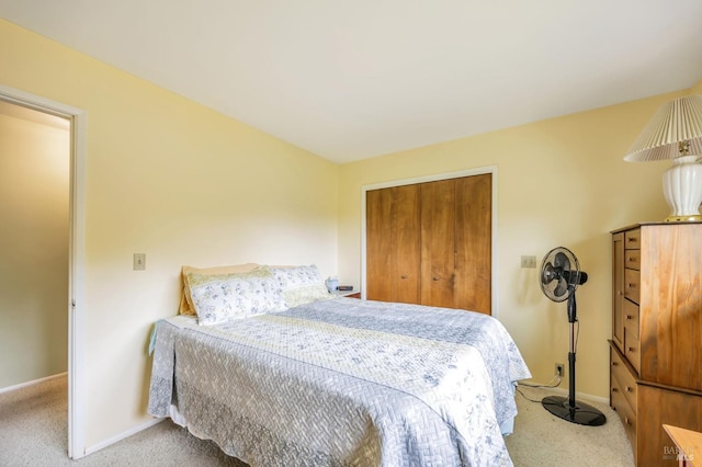 bedroom with carpet, a closet, and baseboards