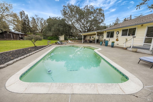 pool with a patio and a yard